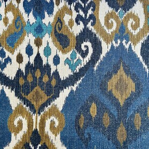 May include: Blue, gold, and white patterned fabric with an ikat design. The fabric has a textured woven look.