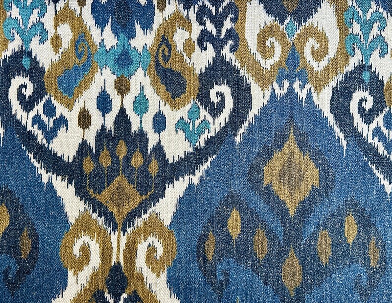 May include: Blue, gold, and white patterned fabric with an ikat design. The fabric has a textured woven look.