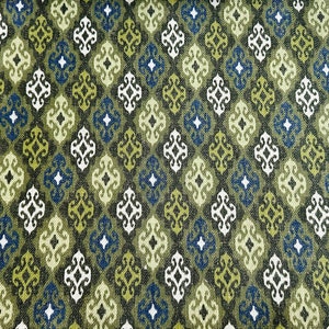 May include: Green, blue, and white patterned fabric with a geometric design. The fabric has a textured surface.