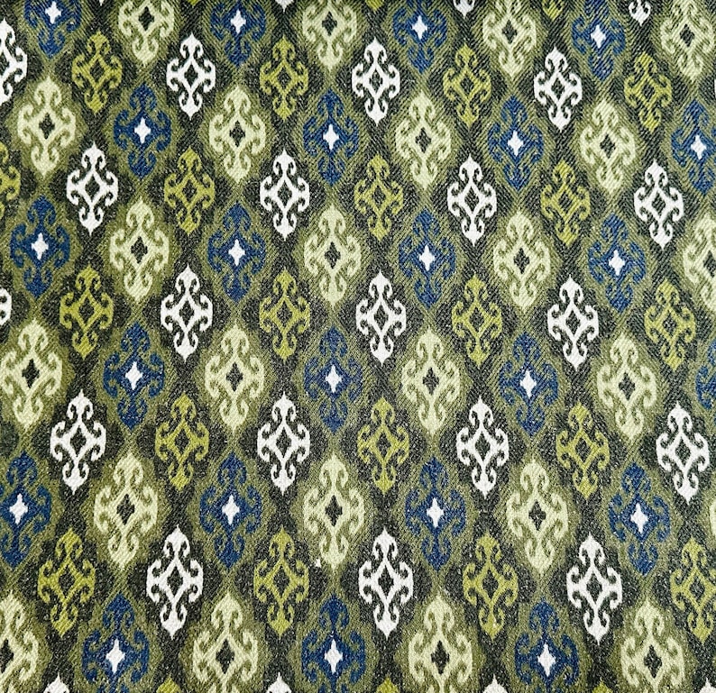 May include: Green, blue, and white patterned fabric with a geometric design. The fabric has a textured surface.