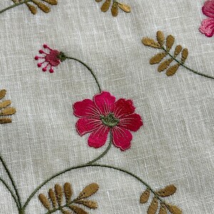 May include: White fabric with embroidered pink flowers and gold leaves. The fabric has a subtle texture.