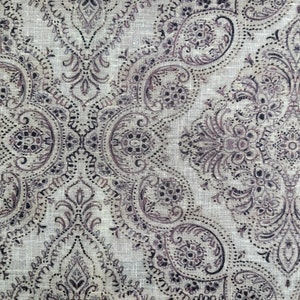 May include: A beige fabric with a brown paisley pattern. The fabric has a subtle linen texture.