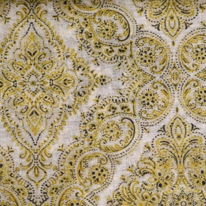 May include: A white fabric with a repeating pattern of gold and black paisley designs. The fabric has a subtle texture.