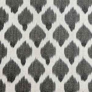 May include: Black and white fabric with a repeating geometric pattern. The pattern is a diamond shape with a smaller diamond shape inside. The fabric has a textured look.
