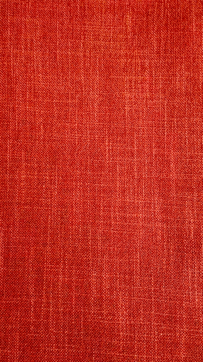 May include: Close-up of a red fabric with a textured woven pattern.