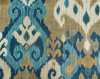 May include: Blue, beige, and white patterned fabric with an ikat design. The fabric has a woven texture.