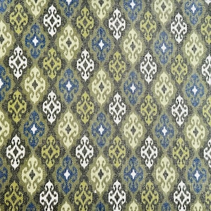 May include: A repeating pattern of green, blue, and white geometric shapes on a dark green background. The pattern is reminiscent of a traditional textile design.