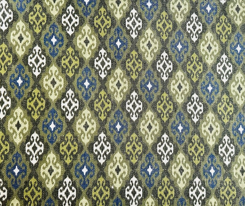 May include: A repeating pattern of green, blue, and white geometric shapes on a dark green background. The pattern is reminiscent of a traditional textile design.
