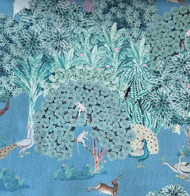 May include: A blue and green patterned fabric featuring a jungle scene. The fabric depicts peacocks, monkeys, deer, and trees.