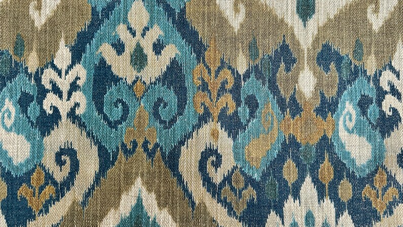 May include: Blue, brown, and white ikat fabric with a repeating pattern of swirls and leaves.