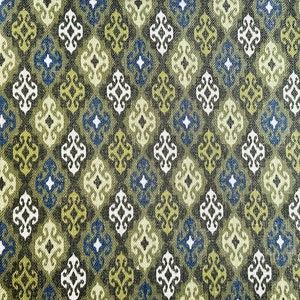 May include: A repeating pattern of green, blue, and white geometric shapes on a dark brown background. The pattern is reminiscent of a traditional textile design.