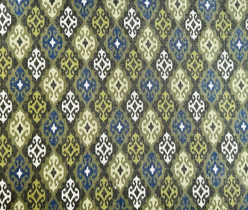 May include: A repeating pattern of green, blue, and white geometric shapes on a dark brown background. The pattern is reminiscent of a traditional textile design.