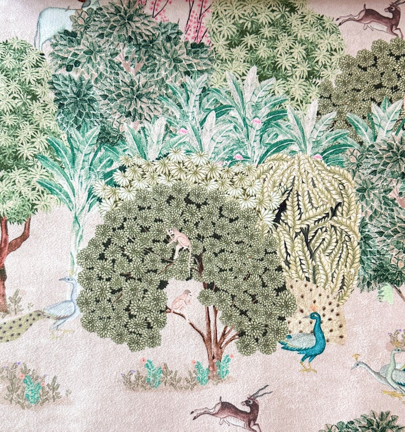 May include: A pink background with a green and white floral pattern. The pattern includes peacocks, deer, monkeys, and birds. The design is reminiscent of a traditional Indian textile.