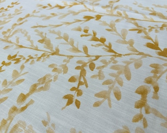May include: White fabric with a subtle pattern of yellow leafy branches. The fabric has a soft, textured look.