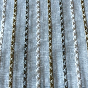 May include: White fabric with vertical stripes of woven brown, gray, and white thread.
