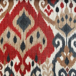 May include: Red, brown and black patterned fabric with an ikat design. The fabric has a woven texture.