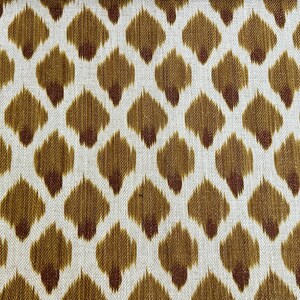 May include: A white fabric with a repeating pattern of brown and maroon teardrop shapes.