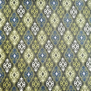 May include: A green, blue, and white fabric with a repeating geometric pattern. The pattern is made up of small diamonds and squares.