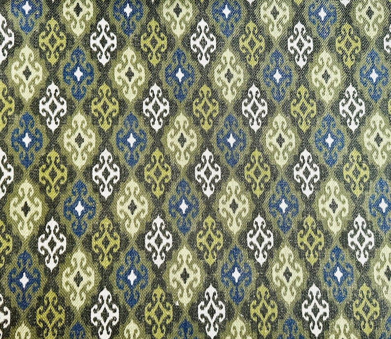 May include: A green, blue, and white fabric with a repeating geometric pattern. The pattern is made up of small diamonds and squares.