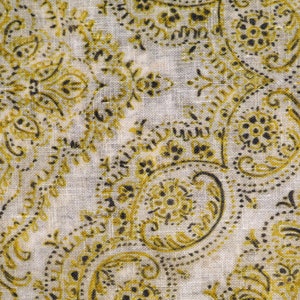 May include: A white fabric with a paisley pattern in shades of gold and black.