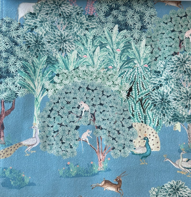 May include: A blue and green patterned fabric featuring a jungle scene. The fabric depicts peacocks, monkeys, deer, and trees.