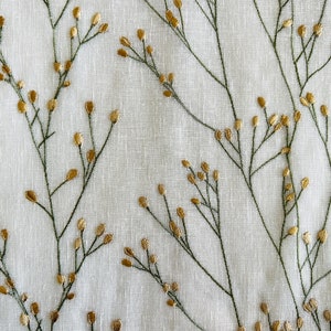 May include: White fabric with an embroidered pattern of green stems and gold leaves.