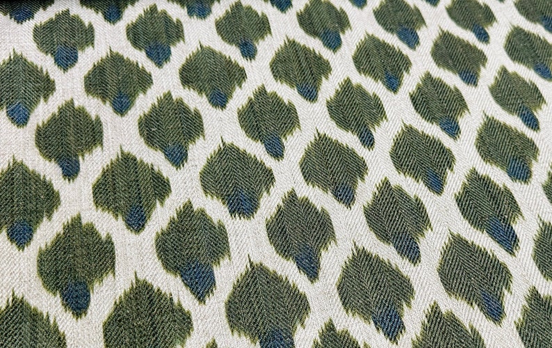 May include: Green and blue ikat fabric with a repeating pattern of abstract shapes.