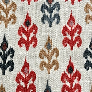 May include: A white fabric with a repeating pattern of red, black, and brown stylized floral designs.