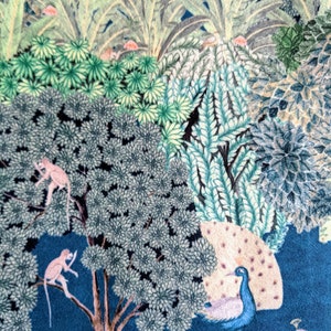 May include: A blue and green patterned fabric with a peacock, two monkeys, and various trees. The fabric has a vintage style and is perfect for crafting projects.