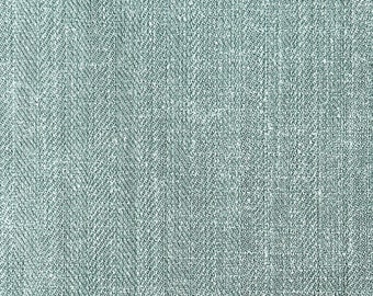 May include: A close-up of a light blue fabric with a herringbone weave pattern.