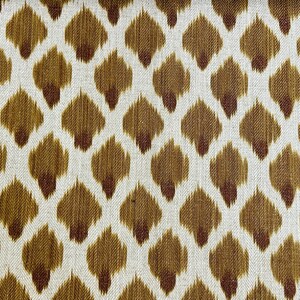 May include: A white fabric with a brown and red ikat pattern. The pattern is a repeating design of small, teardrop-shaped figures.