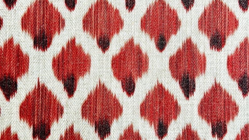 May include: Red and white ikat fabric with a repeating pattern of small, teardrop-shaped designs.