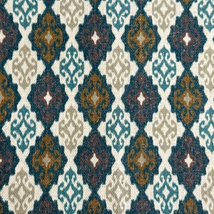 May include: A fabric with a repeating pattern of diamond shapes in shades of teal, brown, beige, and white. The pattern is intricate and features a stylized floral design.