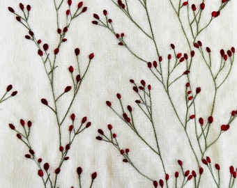 May include: Embroidered fabric with a white background and a repeating pattern of green stems with small red berries.