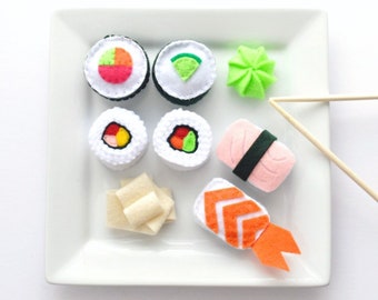 Felt Sushi ... comes with four sushi rolls, two nigiri, wasabi, ginger, chopsticks and sushi packaging