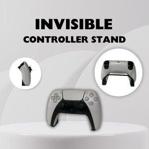 May include: A white PlayStation 5 controller stand with the text "INVISIBLE CONTROLLER STAND" above it. The stand is shown with a white controller on it and a white controller on a stand to the left and right of the controller on the stand.