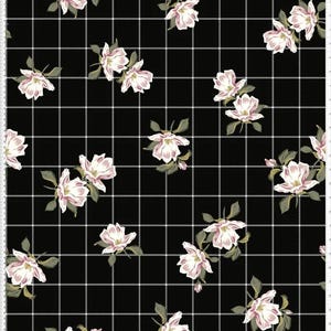 May include: Black fabric with a white grid pattern and scattered pink and white floral designs. The flowers have green leaves and are arranged in a repeating pattern across the fabric.