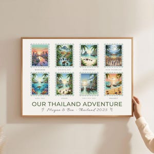 May include: A framed print featuring eight colorful illustrations of Thailand destinations, resembling postage stamps. Destinations include Bangkok, Chiang Mai, and Phuket. The text "OUR THAILAND ADVENTURE" and names are below the images.