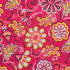 May include: Bright pink fabric with a repeating floral pattern. The design features stylized flowers and leaves in yellow, white, black, and light blue. The fabric has a ruler along the bottom edge, showing measurements in inches.
