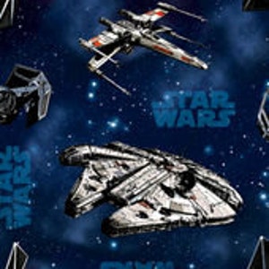 May include: A blue and white space-themed fabric with images of the Millennium Falcon, X-Wing, and TIE Fighter spaceships. The fabric also features the text "STAR WARS" repeated throughout.