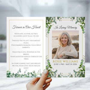 May include: A memorial card with the text "Forever in Our Heart" and "In Loving Memory". The card features a photo of a woman, framed by green foliage. The card includes the name "Rosie Williams" and dates "June 1, 1965 - May 10, 2026".