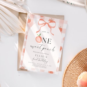 May include: A peach-themed first birthday invitation with the text "SHE IS ONE sweet peach." The invitation features a peach and bow design on a pink gingham background. The details include the date, time, and location of the party.