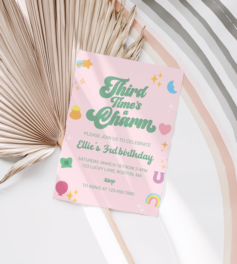 May include: A pink birthday invitation with the text "Third Time's a Charm" in green and white. The invitation includes the details for Ellie's 3rd birthday, with decorative stars, a rainbow, and a horseshoe.