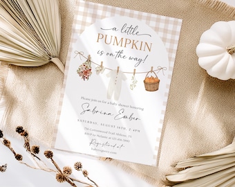May include: Baby shower invitation with the text "a little PUMPKIN is on the way!" in a beige and white gingham pattern. The invitation includes a clothesline with baby clothes and a basket of pumpkins. The invitation is for Sabrina Ember.