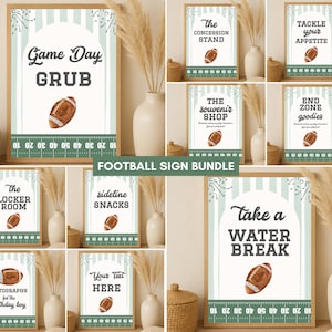 May include: A collection of framed signs with football-themed text and illustrations. The signs feature phrases like "Game Day Grub" and "Take a Water Break," with a football graphic. The signs are in a light green and white color scheme.