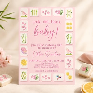 May include: A rectangular pink baby shower invitation card featuring a border of mahjong tiles with illustrations of birds, bamboo, flowers, and lemons. The text reads: crak, dot, bam, baby! join us for mahjong with the mom-to-be Chloe Sanders.