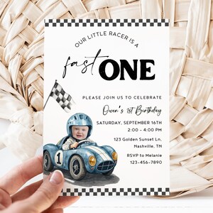 May include: A rectangular birthday invitation card featuring a black and white checkered border. The text reads: Our little racer is a fast ONE, Please join us to celebrate Owen's 1st Birthday, Saturday, September 16th, 2:00-4:00 PM, 123 Golden Sunset Ln, Nashville, TN, RSVP to Melanie 123-456-7890. It includes a watercolor illustration of a child in a blue race car with a checkered flag.