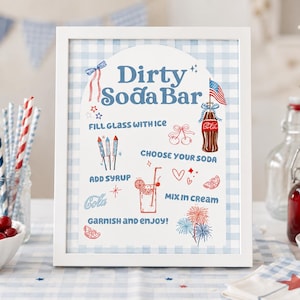 May include: A white framed sign with a light blue gingham background featuring the text Dirty Soda Bar and instructions including Fill glass with ice, Choose your soda, Add syrup, Mix in cream, and Garnish and enjoy, with red and blue illustrations.