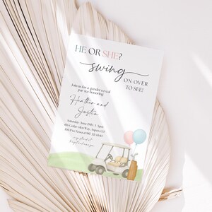 May include: A gender reveal invitation card featuring the text HE OR SHE? swing ON OVER TO SEE! Join us for a gender reveal par tee honoring Heather and Justin. The card includes a watercolor illustration of a golf cart, golf bag, and balloons.