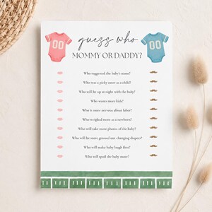 以下が含まれることがあります： 「guess who MOMMY OR DADDY?」と書かれた白いゲームカード。左側に「00」と記されたピンクのベビー用ボディスーツ、右側に「00」と記された青いベビー用ボディスーツが描かれています。下部には10個の質問が並び、回答用にピンクの唇と茶色の口ひげのアイコンが配置されています。